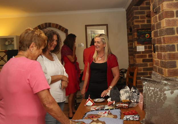 Michele with her creations and interested visitors